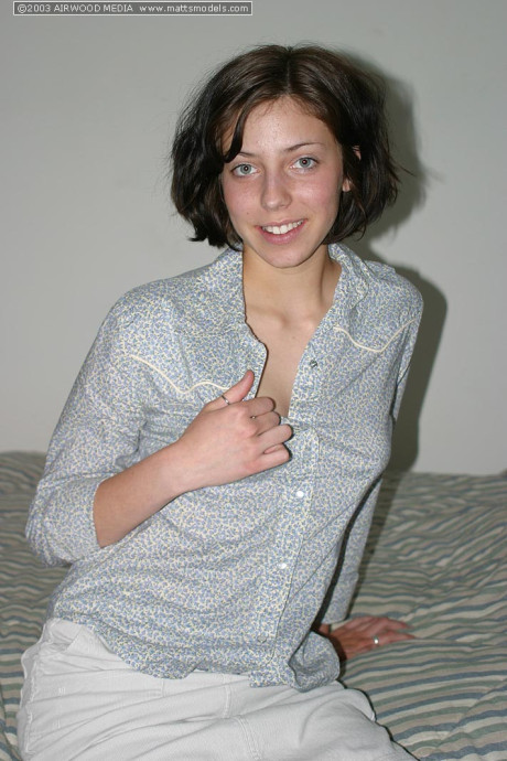 Brunette amateur Nico finger spreads her trimmed snatch after disrobing on bed