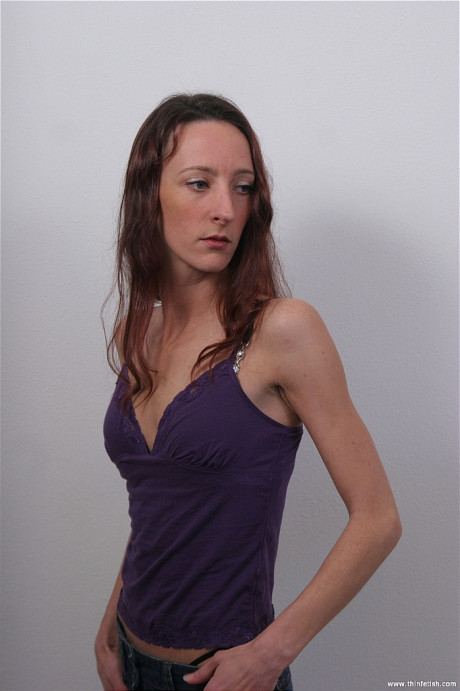 Petite female slowly removes her clothes to model raw undressed