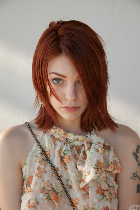 Redheaded teen Bree Daniels shows her slim body and poses in pink lingerie