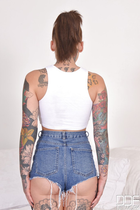 Heavily tattooed alt model Lauren revealing pierced vagina while posing nude