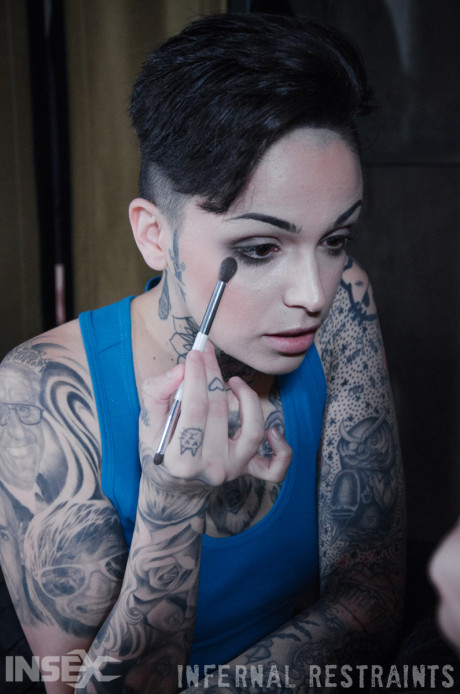 Tattooed female Leigh Raven has her moth forced open during BDSM play