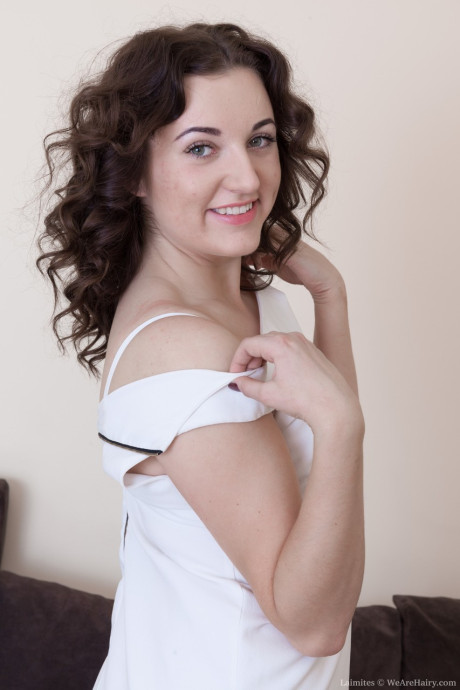Sweet amateur Laimites reveals her bushy crotch and small breasts on a couch