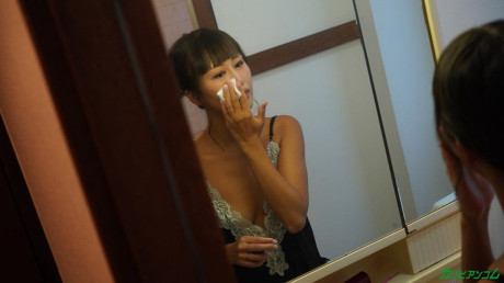 Pretty oriental MILF Miki Hoshino gets stripped and sits on a white bed