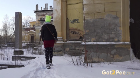 Fine blonde squats in the snow to relieve herself