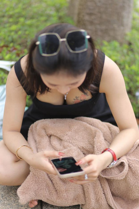 Chinese beauty Julia Nhatle posing in her little black dress & heels outdoors