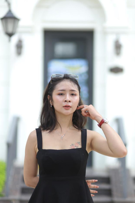 Chinese beauty Julia Nhatle posing in her little black dress & heels outdoors