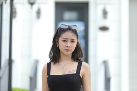 Chinese beauty Julia Nhatle posing in her little black dress & heels outdoors