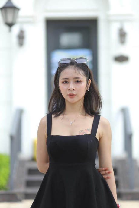 Chinese beauty Julia Nhatle posing in her little black dress & heels outdoors