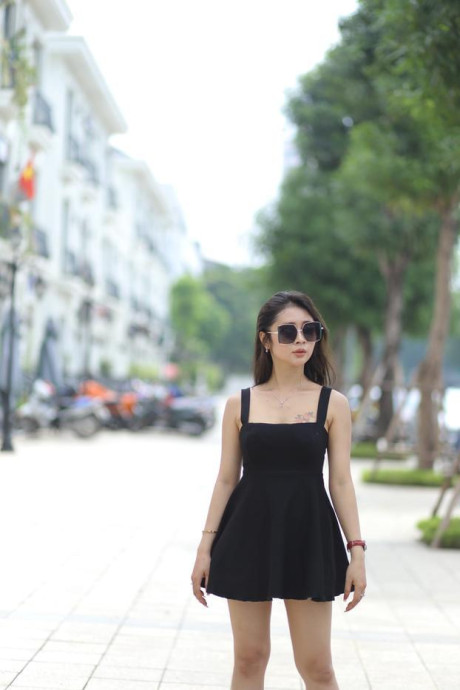 Chinese beauty Julia Nhatle posing in her little black dress & heels outdoors