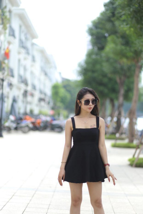Chinese beauty Julia Nhatle posing in her little black dress & heels outdoors