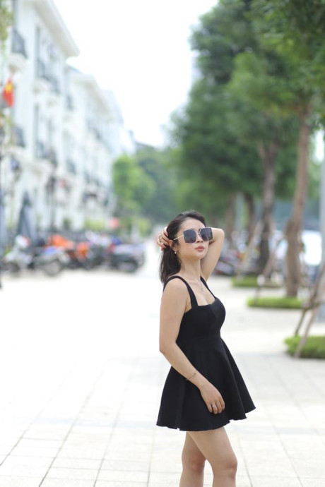 Chinese beauty Julia Nhatle posing in her little black dress & heels outdoors