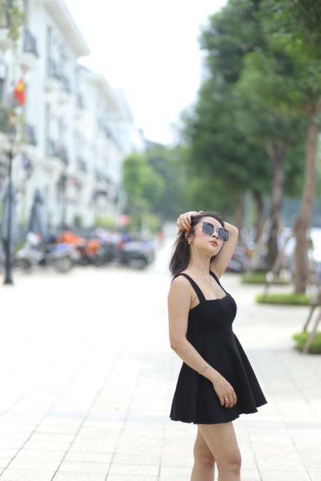 Chinese beauty Julia Nhatle posing in her little black dress & heels outdoors