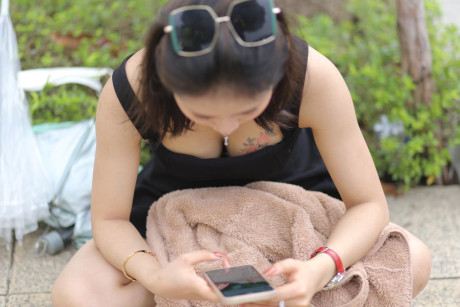 Chinese beauty Julia Nhatle posing in her little black dress & heels outdoors