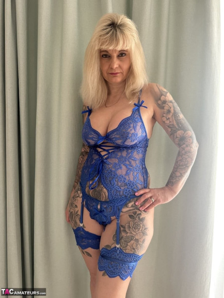 Tattooed blondie Inked MILF uncovers her giant boobs while removing her underwear