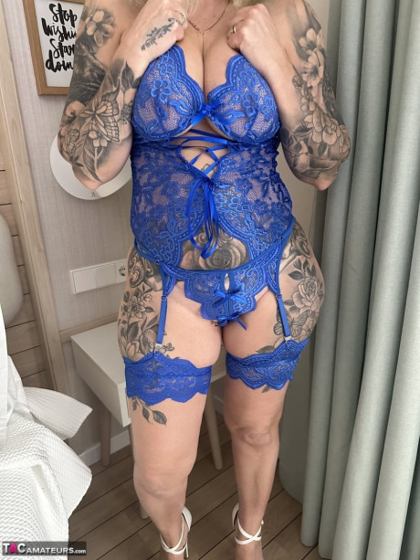 Tattooed blondie Inked MILF uncovers her giant boobs while removing her underwear