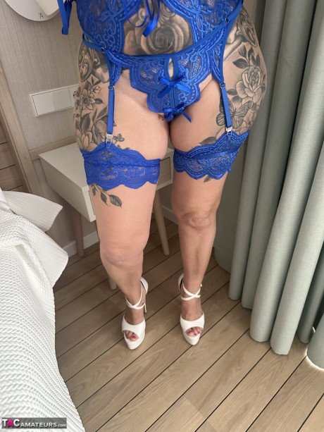 Tattooed blondie Inked MILF uncovers her giant boobs while removing her underwear