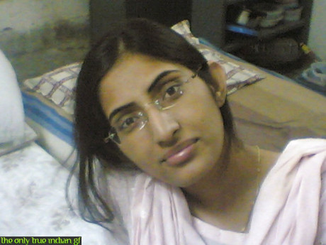 Indian girl girl woman takes selfies in a mirror while wearing a see-through tank top