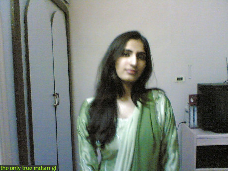 Indian girl girl woman takes selfies in a mirror while wearing a see-through tank top