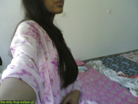 Indian girl girl woman takes selfies in a mirror while wearing a see-through tank top