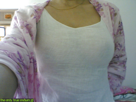 Indian girl girl woman takes selfies in a mirror while wearing a see-through tank top