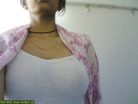 Indian girl girl woman takes selfies in a mirror while wearing a see-through tank top