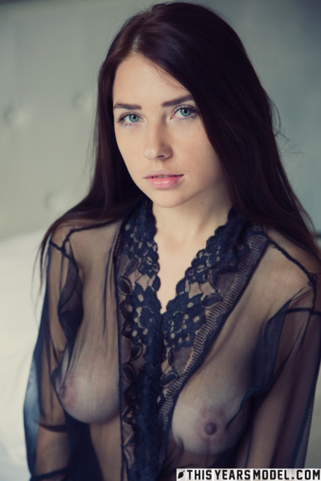 Beautiful brunette Niemira removes sheer lingerie to stand nude on a bed