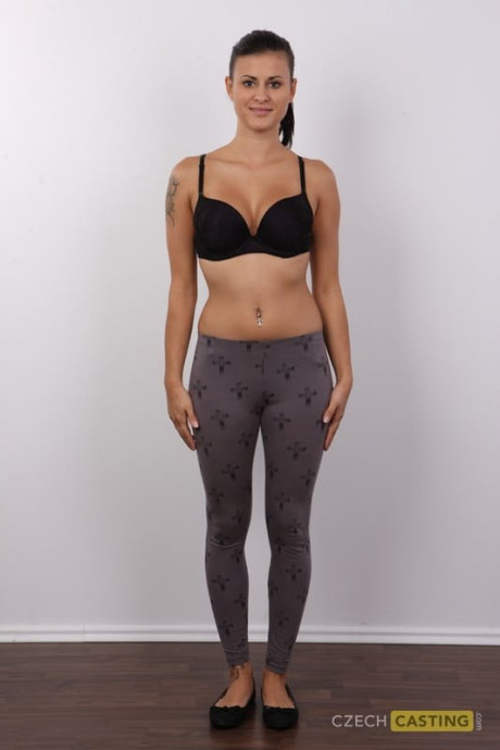 Brunette amateur removes leggings and underwear to stand undressed in a ponytail