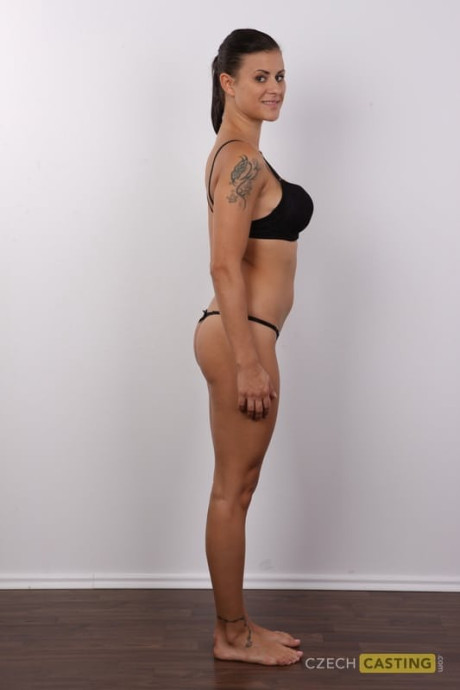 Brunette amateur removes leggings and underwear to stand undressed in a ponytail