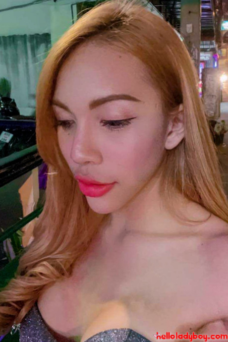Blue-eyed oriental t-girl shows off her alluring figure and poses provocatively