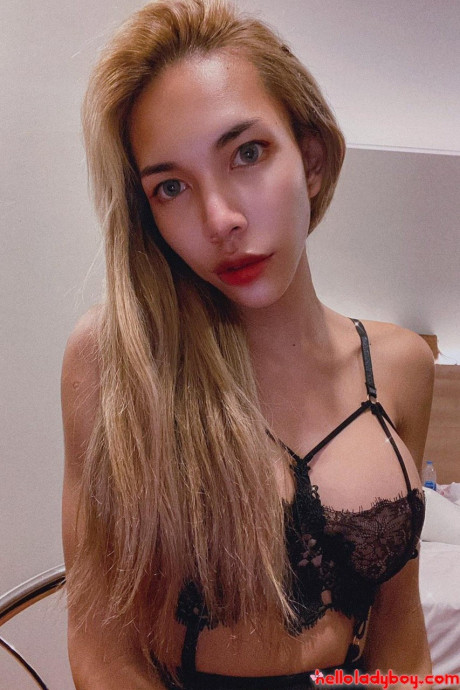 Blue-eyed oriental t-girl shows off her alluring figure and poses provocatively