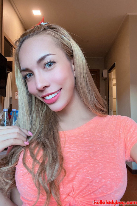 Blue-eyed oriental t-girl shows off her alluring figure and poses provocatively