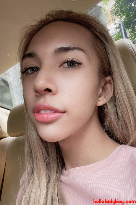 Blue-eyed oriental t-girl shows off her alluring figure and poses provocatively