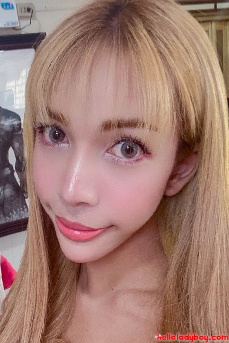 Blue-eyed oriental t-girl shows off her alluring figure and poses provocatively
