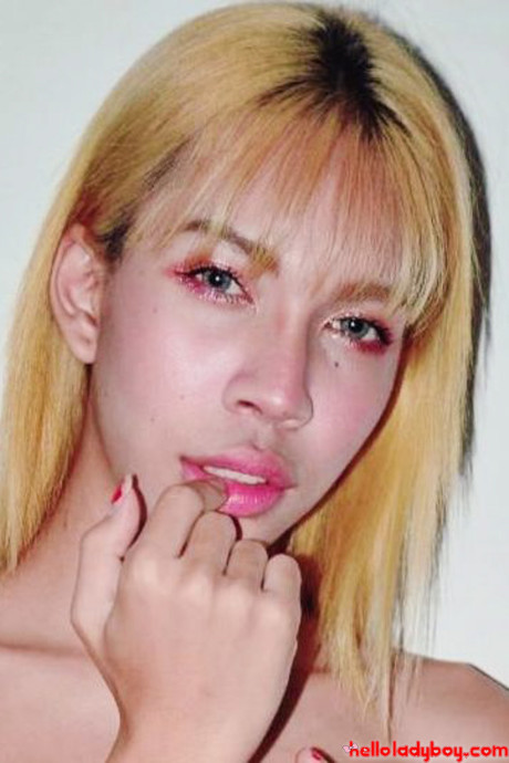 Blue-eyed oriental t-girl shows off her alluring figure and poses provocatively
