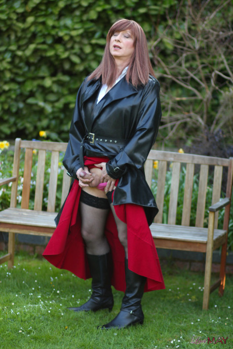 Juicy Luci May wore her fine lovely long rubber trench coat and a long red skirt