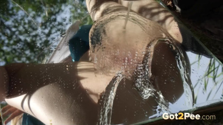 Hot blondy sprays her pee streams over a mirror