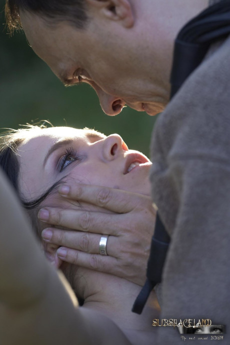 Naked brunette Ally Style is roasted over a fire during BDSM training