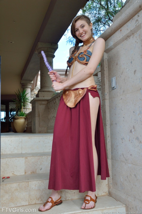 Adorable teen in a princess costume Eva toys her pussy in public