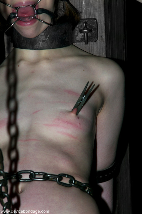 Fresh teenie sub Kristine restrained with chains for punishment in metal bondage BDSM