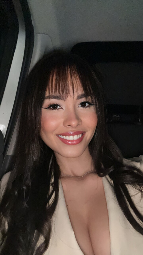 Pretty brunette Nina Carvalhoo sports a winning smile during a SFW shoot