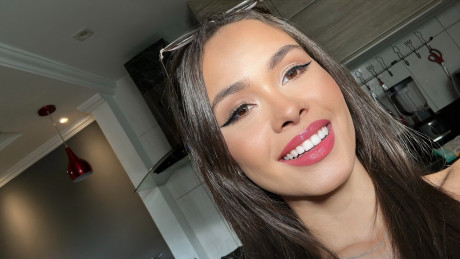 Pretty brunette Nina Carvalhoo sports a winning smile during a SFW shoot