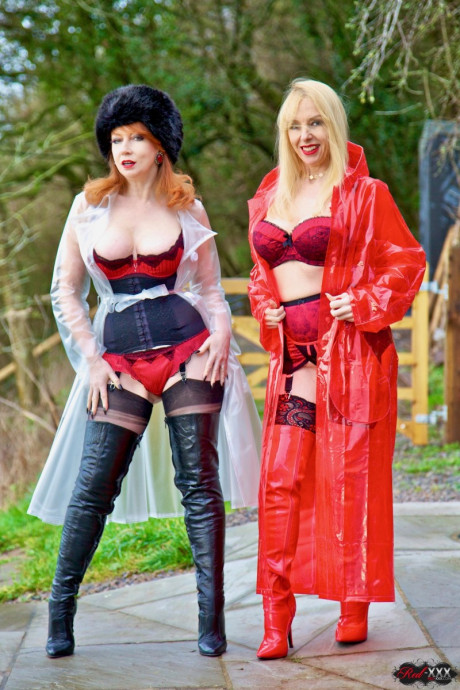 British lesbians expose boobs while modelling raincoats and thigh-high boots