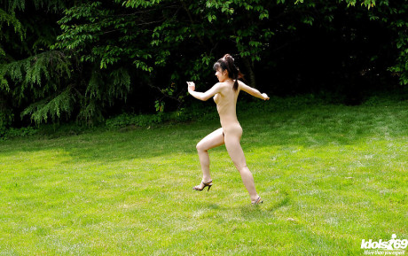 Lovely asian teenie babe with tiny melons posing undressed and having fun outdoor