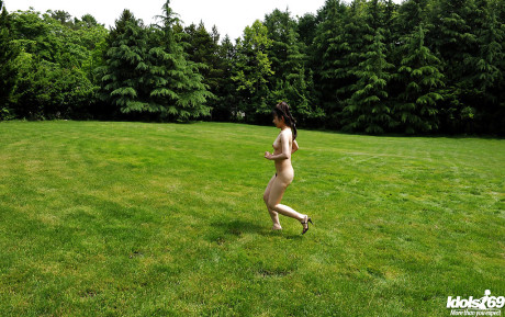 Lovely asian teenie babe with tiny melons posing undressed and having fun outdoor
