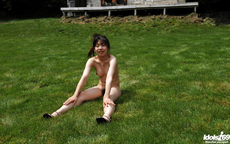 Lovely asian teenie babe with tiny melons posing undressed and having fun outdoor