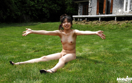 Lovely asian teenie babe with tiny melons posing undressed and having fun outdoor