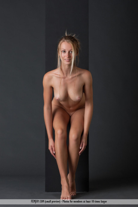 Pretty skank girlfriend chick Carisha holds her nice tits while modelling naked