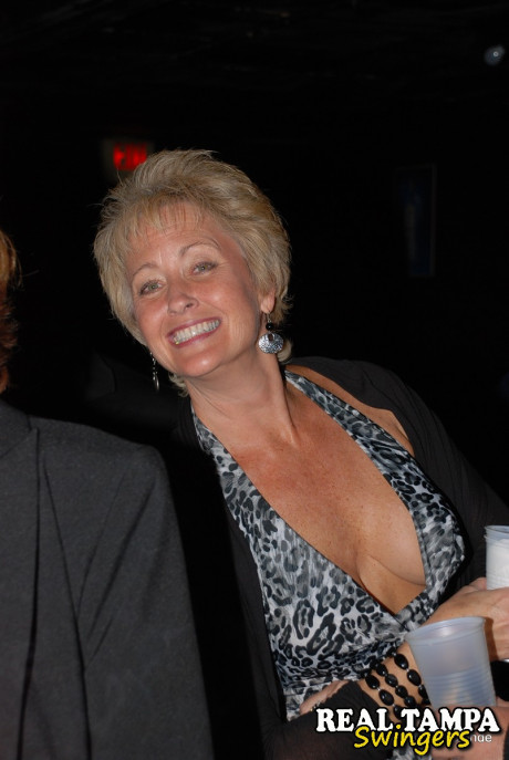 Mature swinger Tracy lick reveals her large juggs and gets blacked at a club