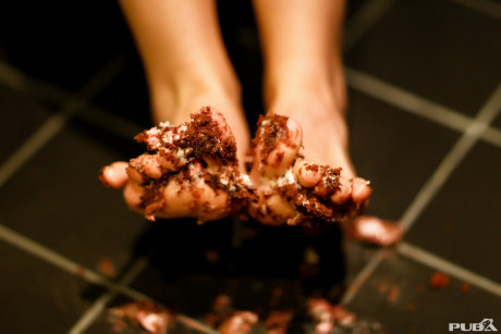 Undressed pornstar Kayla Jane Danger flaunts her behind while getting messy with food