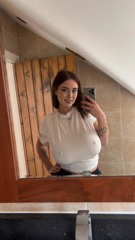 Adorable blue eyed teenie with humongous juggs Brooke Mills poses in a tight shirt